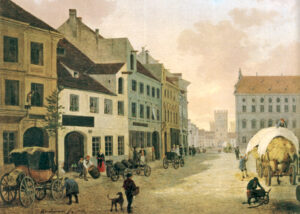 Kleine Anfänge: Die Spatenbrauerei in der Neuhauser Straße in München um 1840 (weißes Gebäude auf der linken Seite), im Hintergrund das Karlstor (Foto: Stadtarchiv München)